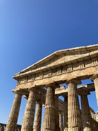 Low angle view of temple against clear blue sky