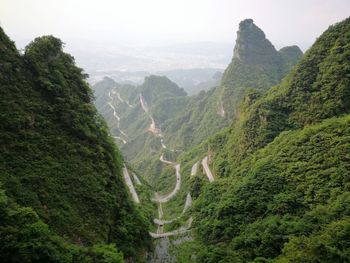 High angle view of valley and mountains against sky