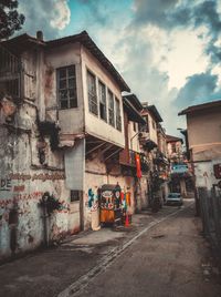 Street amidst buildings in town against sky