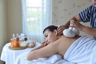 Midsection of woman lying on table