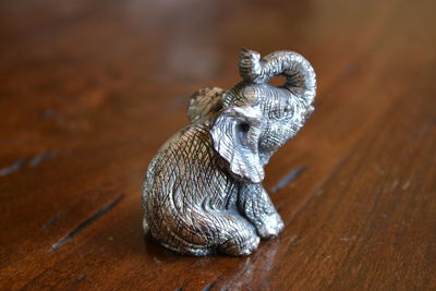 Close-up of silver elephant figurine on table