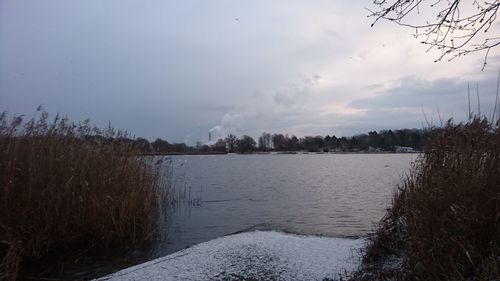 Scenic view of lake against sky during winter