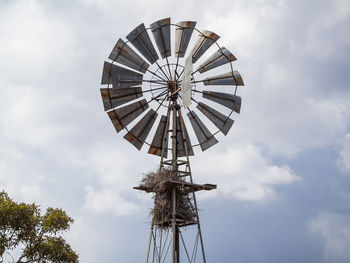 Low angle view of traditional windmill against sky, kruger national park, south africa