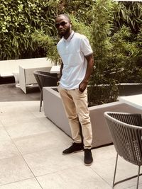 Full length of man standing on seat against plants