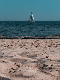 Sailboat in sea against sky