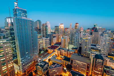 Aerial view of modern buildings in city against sky