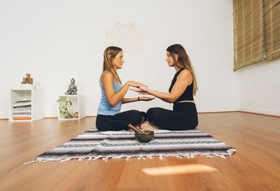 Two women doing reiki each other