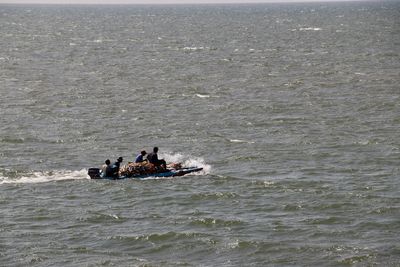 High angle view of men on fishing boat in sea