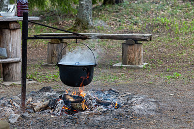 Cooking food on a campfire in the woods, food camping concept, place for a bonfire in the rural hous