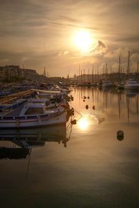 Boats in marina at sunset