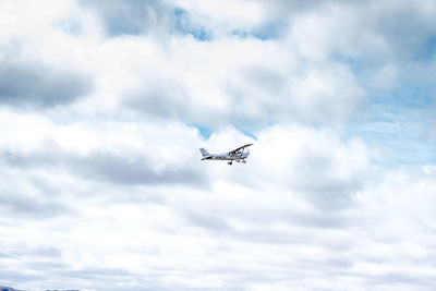 Low angle view of airplane flying in sky