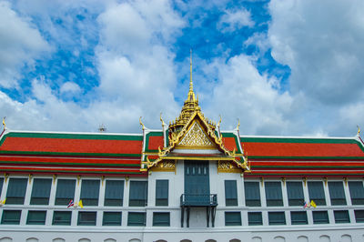 Low angle view of building against cloudy sky