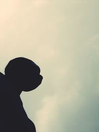 Low angle view of silhouette man standing against sky