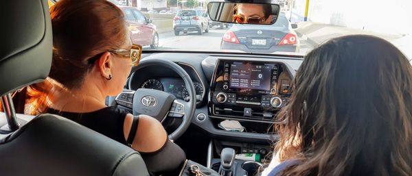 Rear view of woman sitting in car