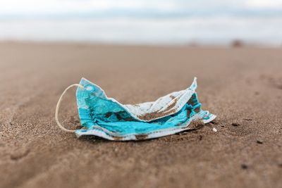 Close-up of blue umbrella on beach