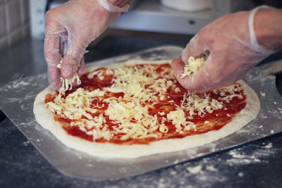 Close-up of hand holding pizza