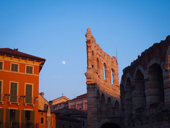Low angle view of buildings against clear blue sky