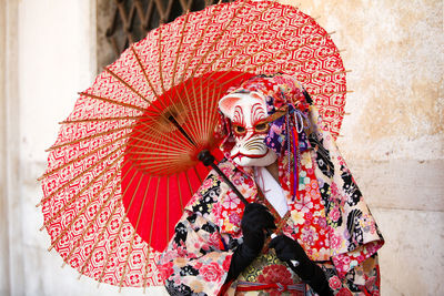 Person wearing venetian mask 