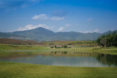 Scenic view of lake and mountains against sky