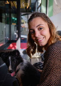 Portrait of young woman with dog