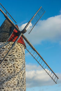 Low angle view of traditional windmill against sky