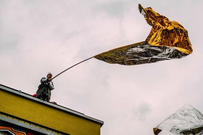 Low angle view of person against sky