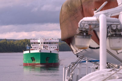 Boats moored at harbor against sky