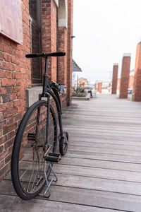 Bicycle on footpath against building