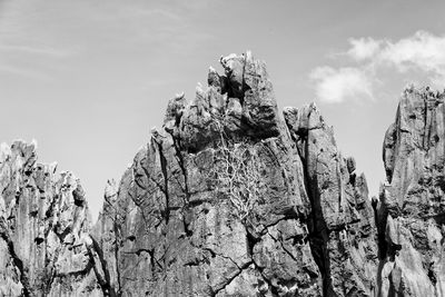 Low angle view of rock formation against sky