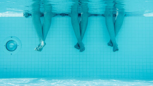 Low section of woman swimming in pool