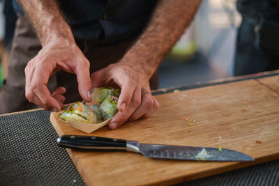 High angle view of man preparing food at market stall