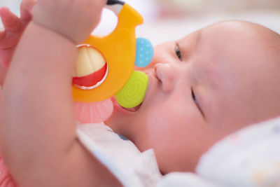 Close-up of woman holding thermometer