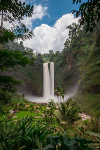 Scenic view of waterfall against sky