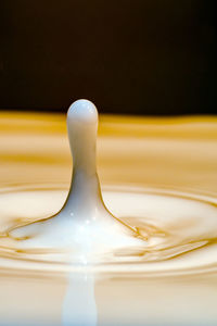 Close-up of water on table against black background