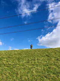 Man on field against sky