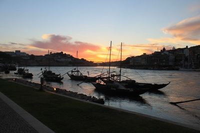 Boats in harbor at sunset