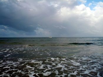 Scenic view of sea against cloudy sky