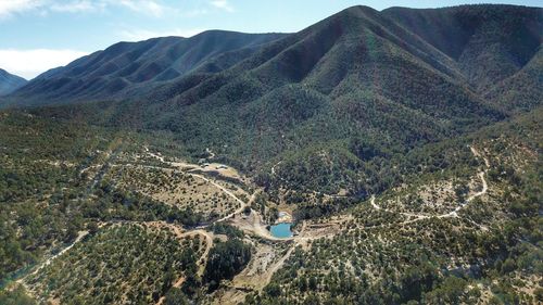 High angle view of land and mountains against sky