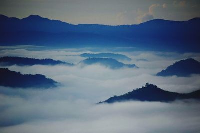 Scenic view of cloudscape mountains against sky