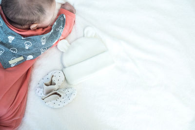 High angle view of cute baby on bed