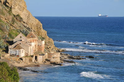 Scenic view of sea and buildings against sky