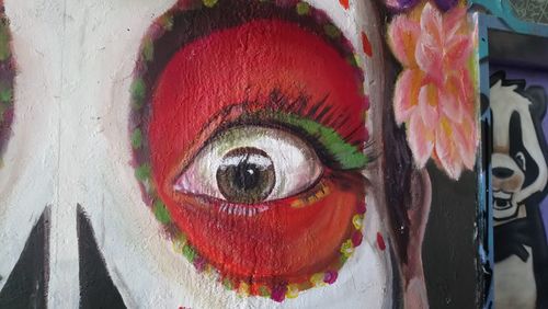 Close-up portrait of young woman with multi colored umbrella