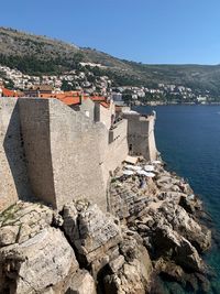 High angle view of townscape by sea against sky