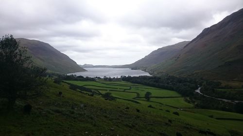 Scenic view of field and mountains against sky
