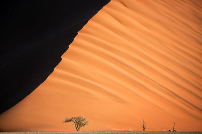 Sand dune against sky during sunset