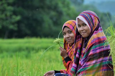 Young women sitting on field