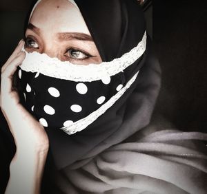 Portrait of young woman covering face