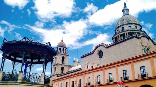 Low angle view of church against cloudy sky