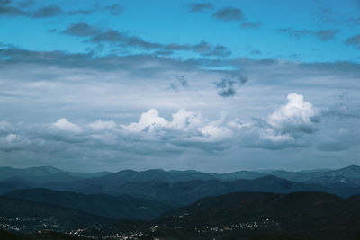 Scenic view of mountains against cloudy sky