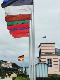 Low angle view of flag against buildings in city